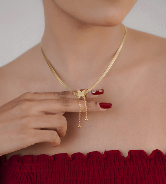 Close-up of gold baroque butterfly pendant on chain – Sri Lanka jewellery