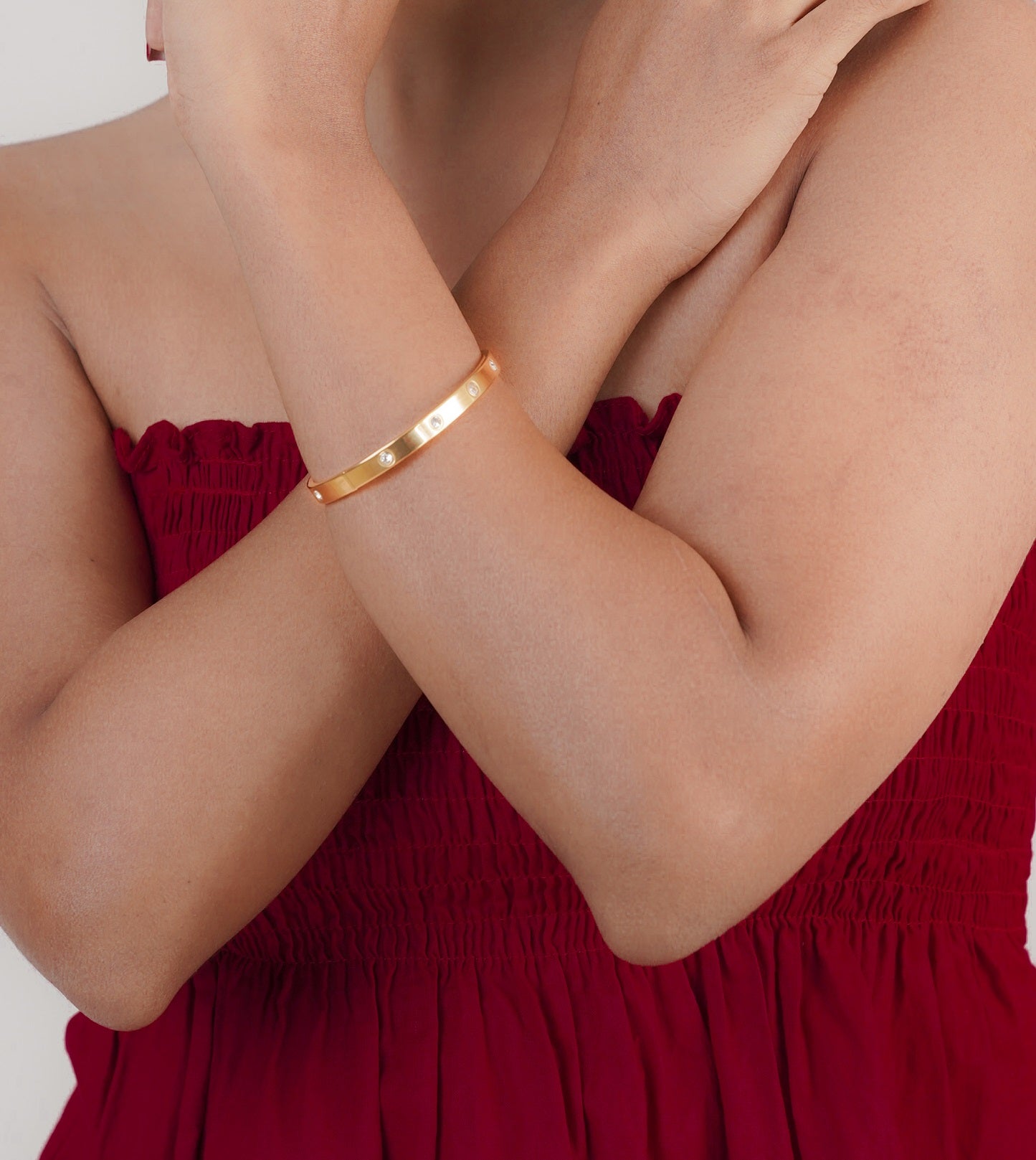Gold lotus pull chain bracelet styled with red dress – Luxteno Sri Lanka