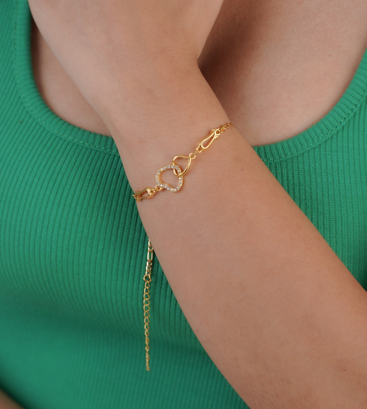 Close-up of gold-plated love charm bracelet on wrist – Sri Lanka jewellery
