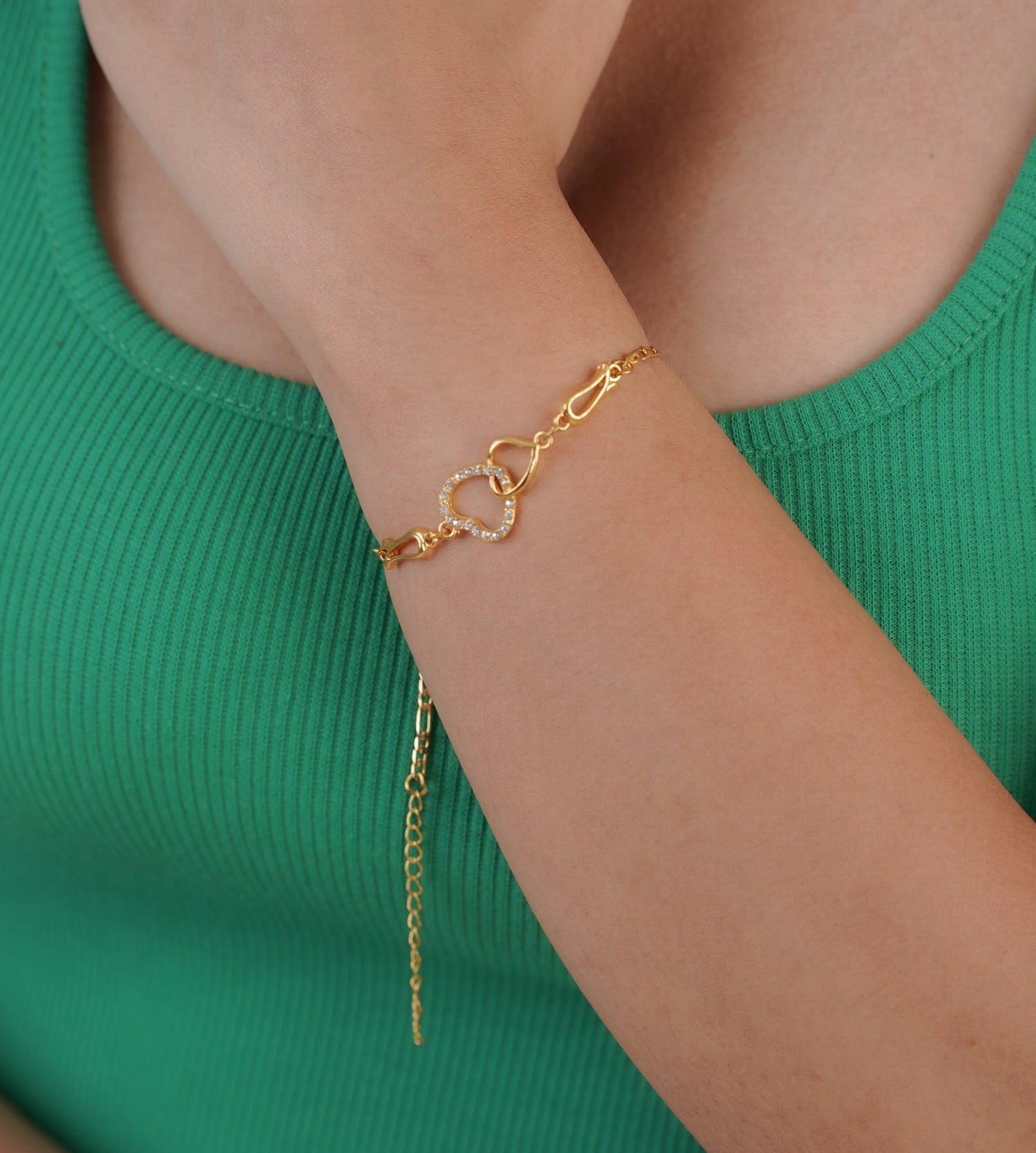 Close-up of gold-plated love charm bracelet on wrist – Sri Lanka jewellery