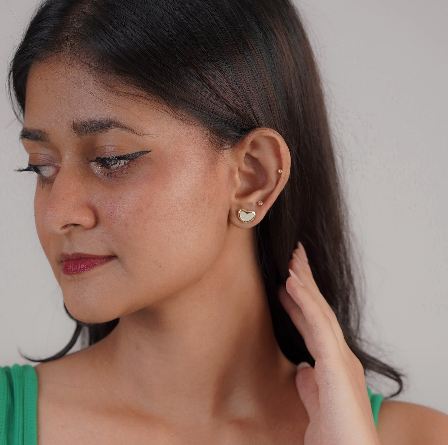 Gold and white heart hoop earrings on ear – Luxteno Sri Lanka