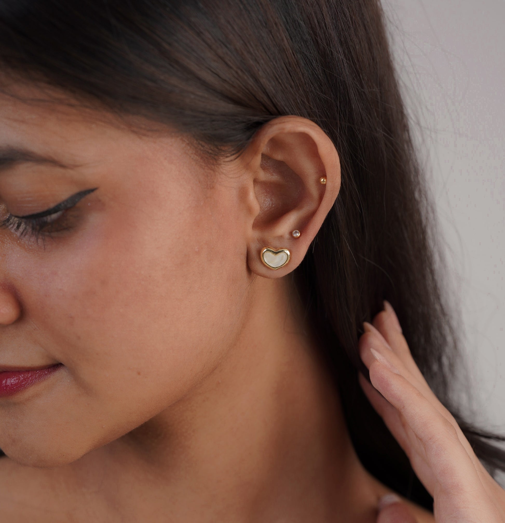 Close-up of gold & white heart hoop earrings – Sri Lanka jewellery