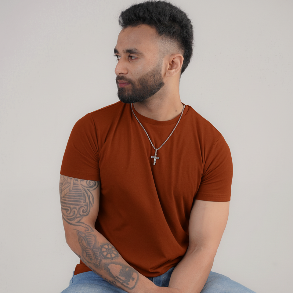 Man wearing a brown t-shirt and a Men's Silver Crystal Cross Necklace, Sri Lanka Luxteno