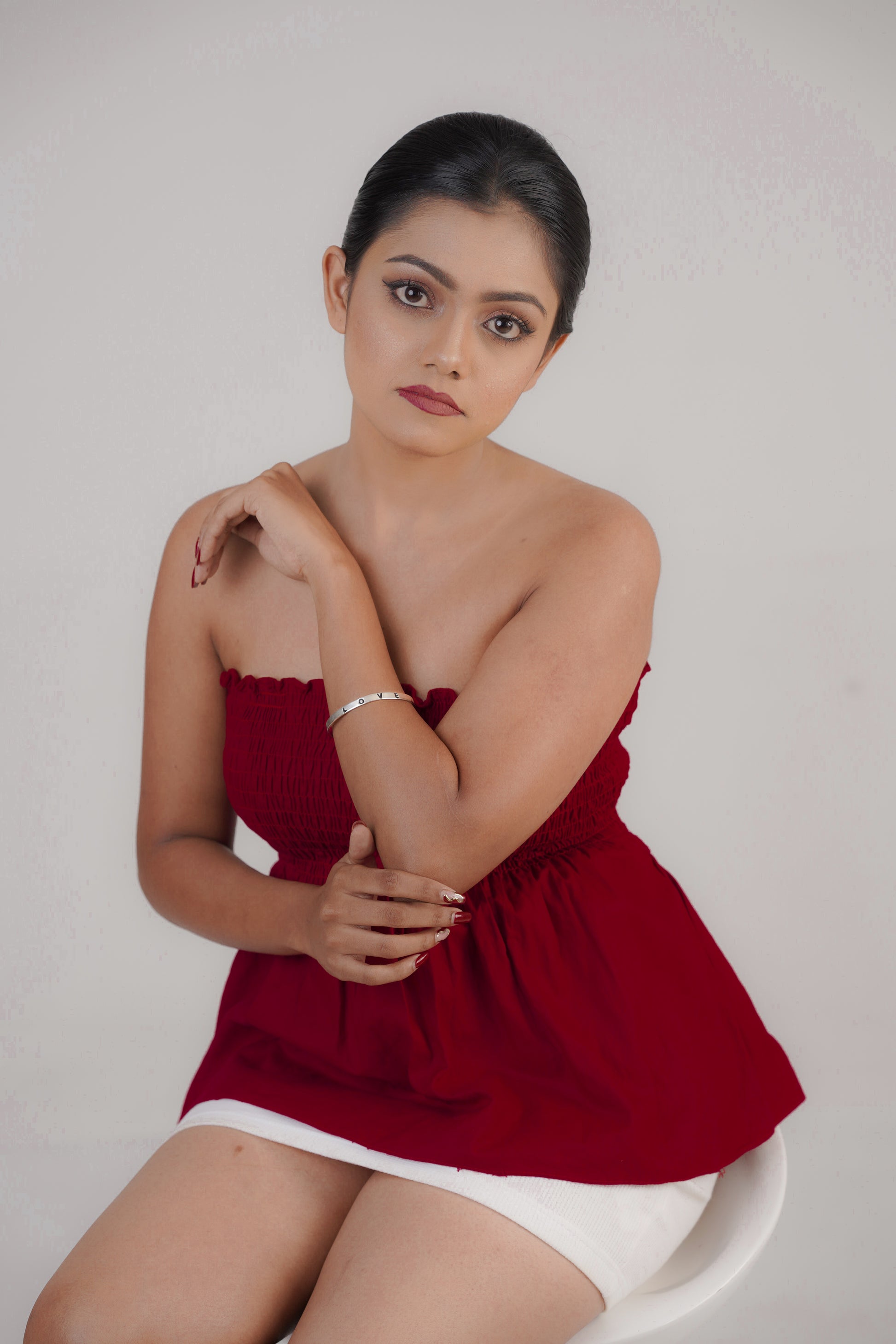 Simple love letter silver bracelet styled with red dress – Luxteno Sri Lanka