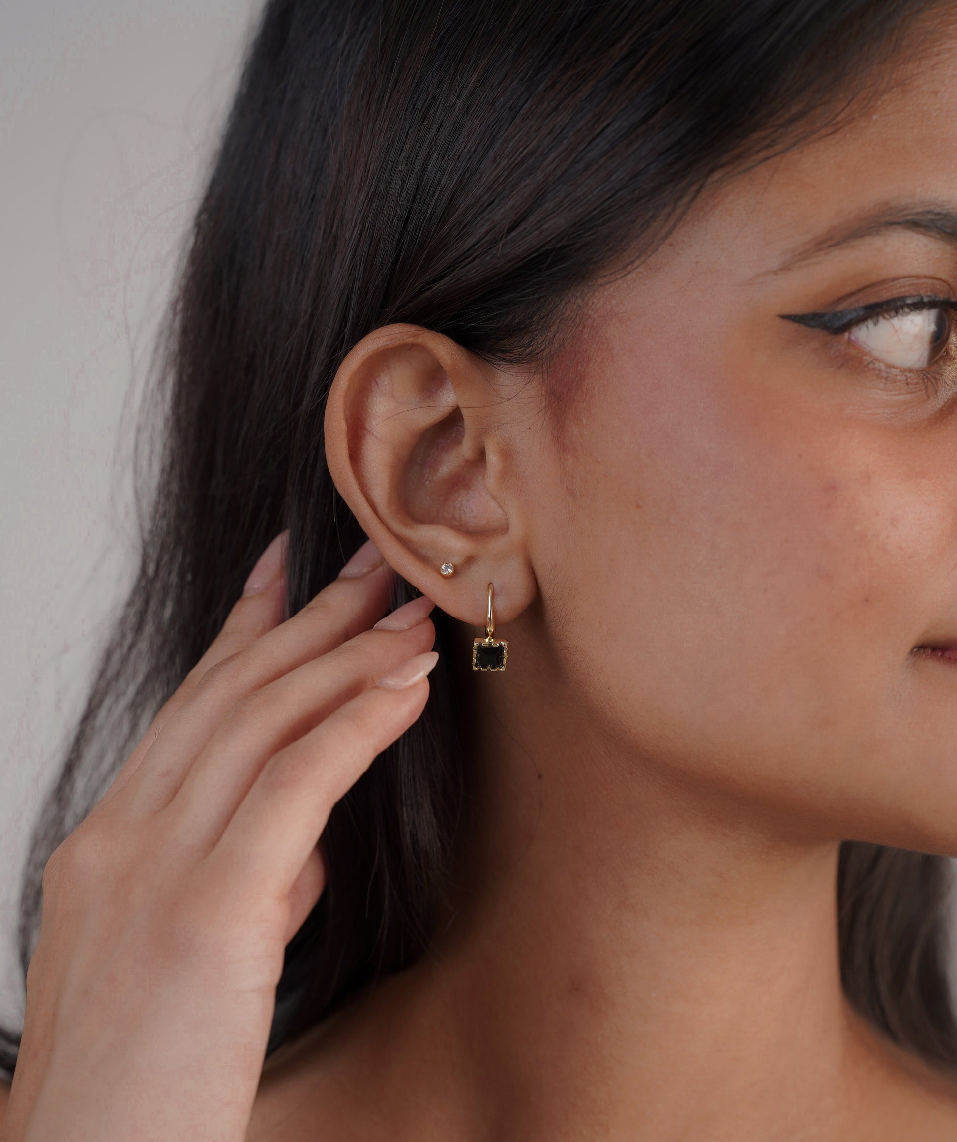 Close-up of gold and black square stud earrings – Sri Lanka jewellery